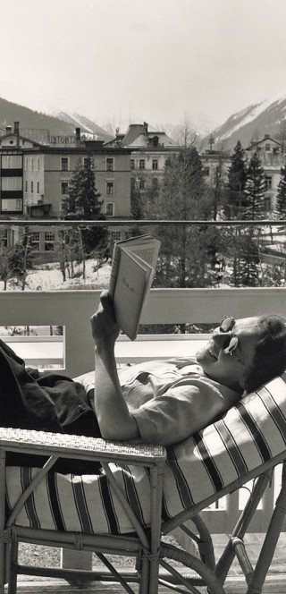 A guest takes a sunbath on the balcony of the Morosani Hotel in the history 