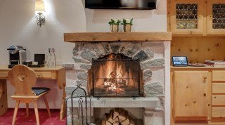 Open fireplace at the "Posthotel" Junior Suite