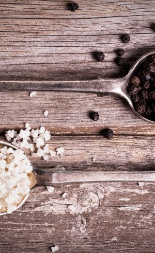 salt and pepper on rustic spoons